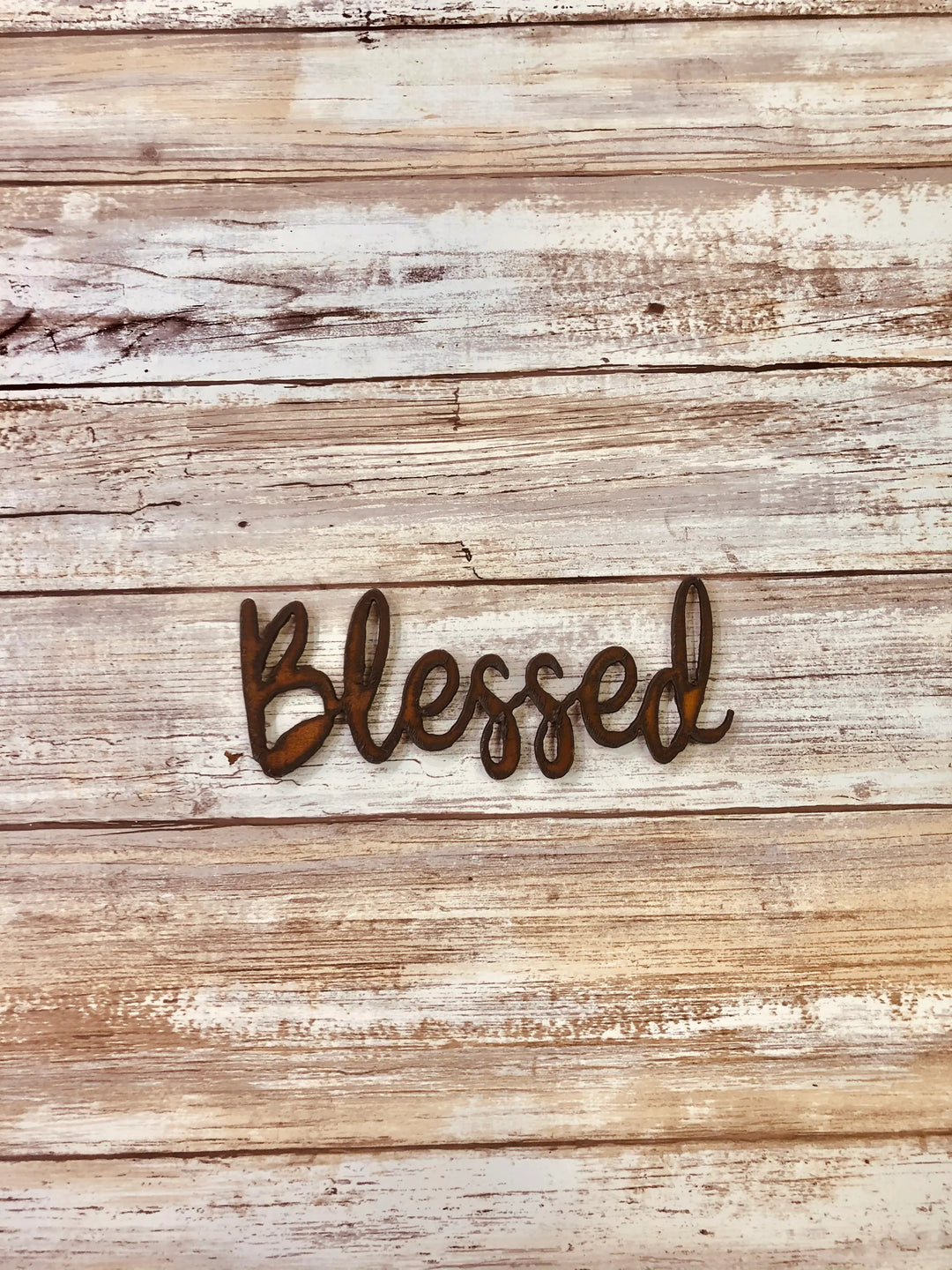 Rustic metal magnet with the word “Blessed” written in cursive style