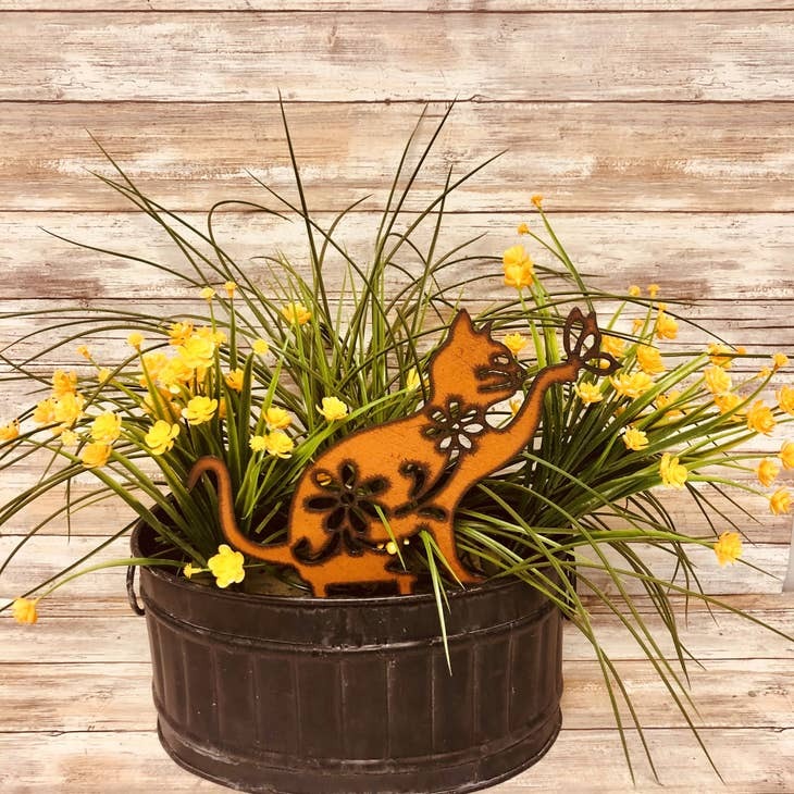 Rusty metal cat garden stake with two spikes for yard display