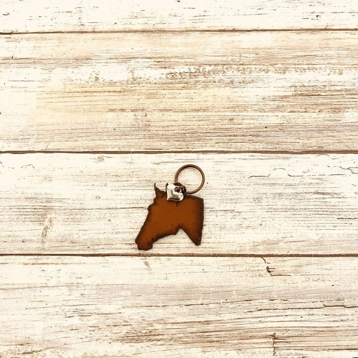 Rusty metal horse head keychain with western-style design