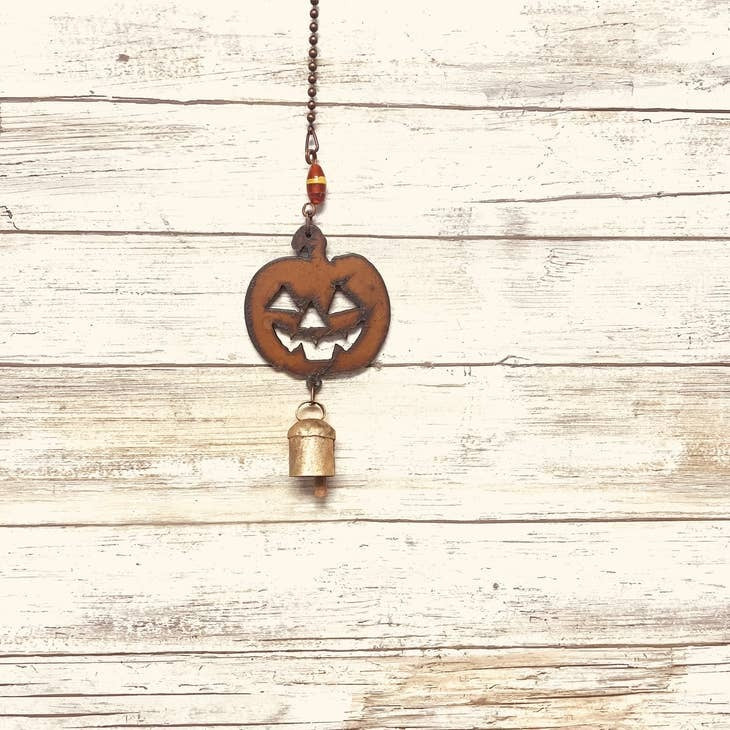 Rustic garden bell chime with jack-o’-lantern face for Halloween decor