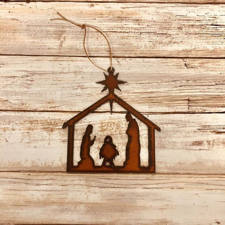 Rustic iron Christmas ornament featuring a nativity scene silhouette