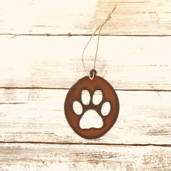 Rustic metal pet ornament with paw print inside an oval frame