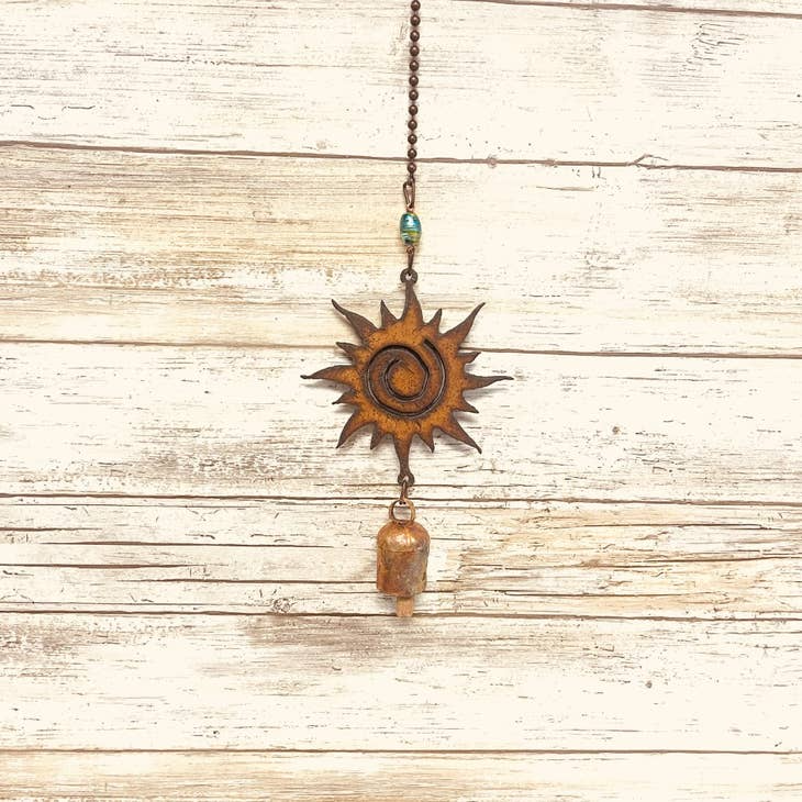 Rusted metal sun-themed garden bell chime for outdoor spaces